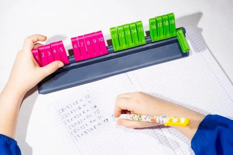 Open exercise book with line 20, analogic counting tool on white background. Stock Photos
