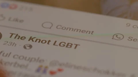 Open the Facebook app and swipe into an LGBT group, and give likes. Stock Footage 300003305
