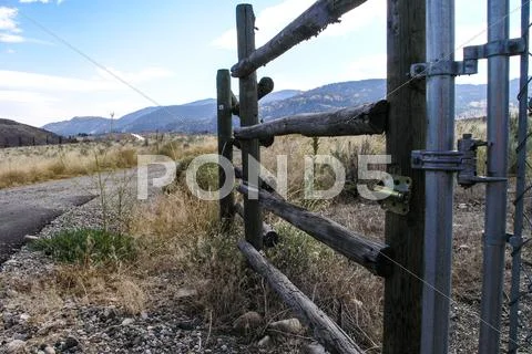 Open fence to dry pasture land Stock Photos