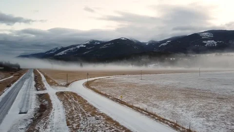 Open field and dirt roads covered in snow Stock Footage 124927229