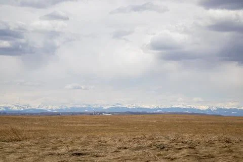 Open Field with Mountain Range Background Stock Photos