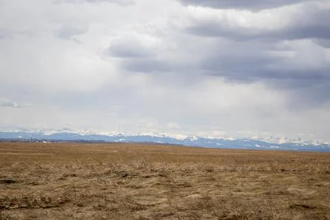 Open Field with Mountain Range Background Stock Photos