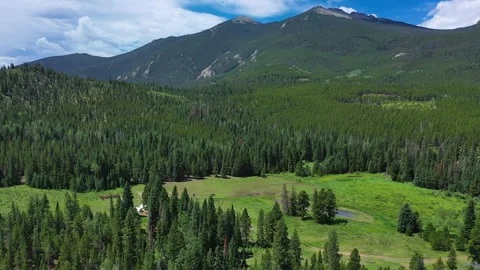 An open field provides the perfect backdrop for campers at Estes Park CO Stock Footage 247363758