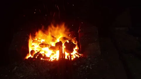 Open fire in the hearth Cleaning, igniting the horn. Sparks fly in.60 fps 4K UHD Stock Footage 201780228