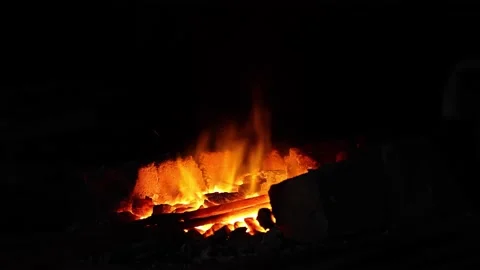 Open fire in the hearth Cleaning, igniting the horn. Sparks fly in.60 fps 4K UHD Stock Footage 203782123