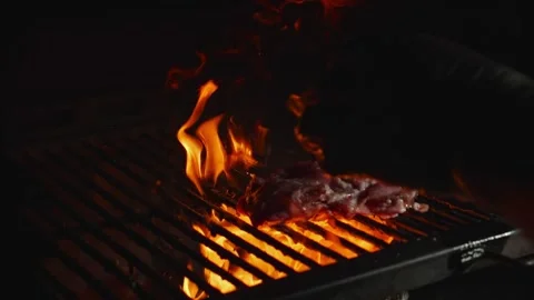 Open flames lick the grill grate. The open flame licks the grill grate. Stock Footage 264412373