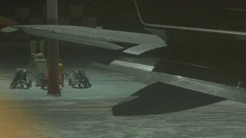 Open the flap on the icy wing of the plane. Winter, night Stock Footage 78728112