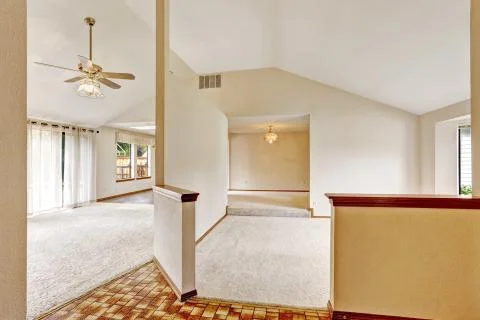 Open floor plan in empty house with vaulted ceiling Stock Photos