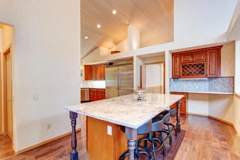 Open floor plan kitchen design features breakfast nook with a kitchen island  Stock Photos