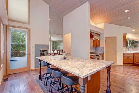 Open floor plan kitchen design features breakfast nook with a kitchen island  Stock Photos