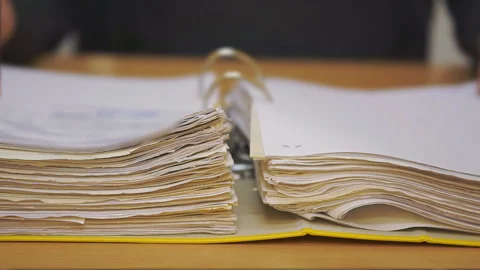 Open folder with documents. Entrepreneur studies financial documents Stock Footage 122700338