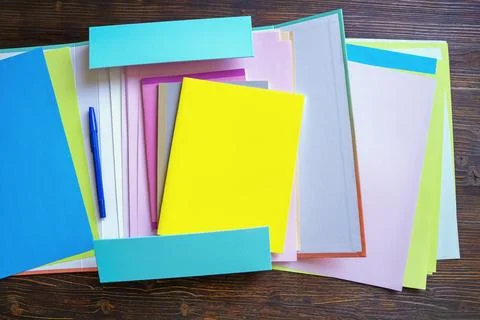 Open folder with workbooks and sheets of paper. Copy space Stock Photos