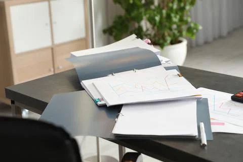 Open folders with documents on office table Stock Photos