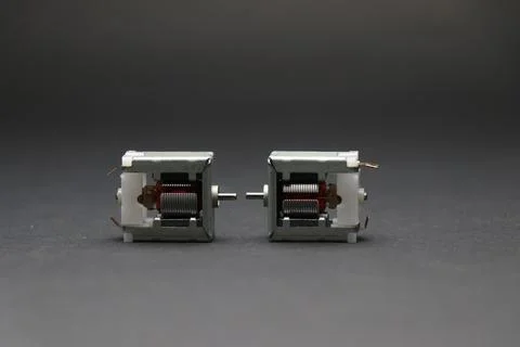 Open frame dc motor exposing internal rotor coils and shaft Stock Photos
