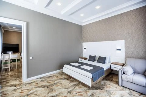 The open front door to the kitchen. White kitchen with wooden countertop and  Stock Photos