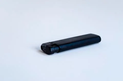 Open front shoot of horizontal black lighter on white surface Stock Photos