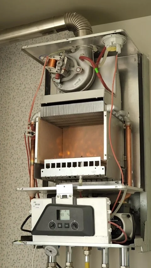 Open gas boiler during maintenance and cleaning in residential apartment heating Stock Footage 346721338