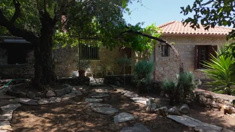 Open Gate to Shaded Stone Cottage Patio Stock Footage 343932676