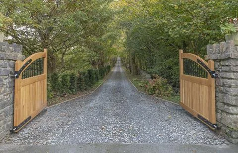 Open gates looking down a driveway Stock Photos
