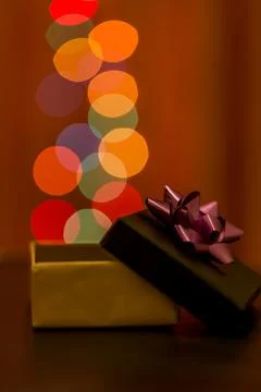 Open gift package with round shaped bokeh lights Stock Photos
