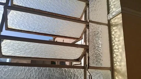 Open glass louvre window frame showing bright sunlight video motion Stock Footage 339301849