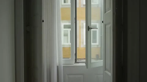 Open glass window overlooking city street as camera slowly gets closer Stock Footage 293495232