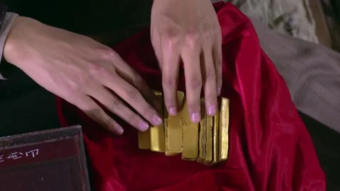 Open gold bars wrapped in red cloth Stock Footage 235267984