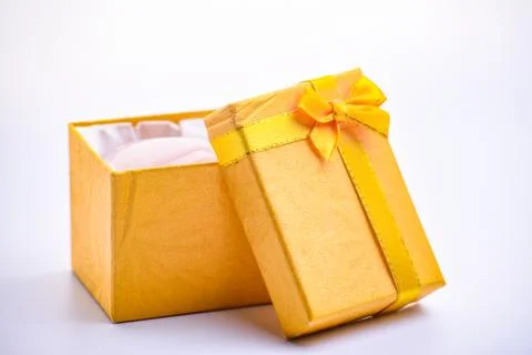 A open gold giftbox on the white table Stock Photos