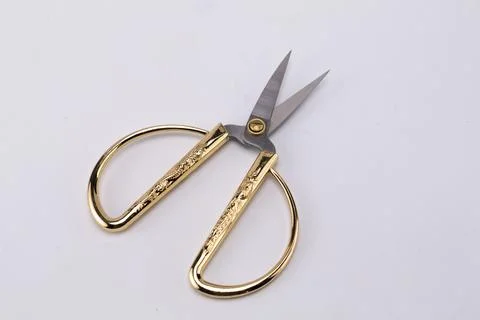 Open Gold-Handled Scissors on White Background, Close-Up View of Sharp Blad.. Stock Photos