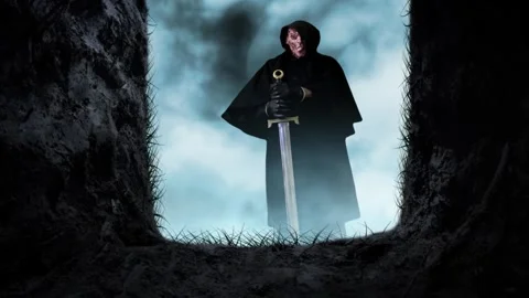 Open Grave Looking at Death with Sword 4K Loop Stock Footage 253581579