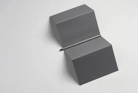 Open gray cardboard box with flaps on a white background Stock Photos