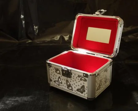 Open gray red makeup case on a black background Stock Photos