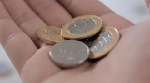 An open hand shows camera a handful of coins 動画素材 58509456