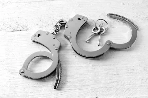 Open handcuffs with keys Stock Photos