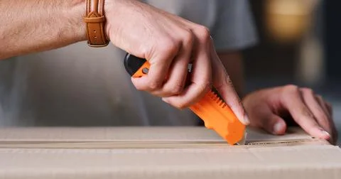 Open, hands and man with box cutter in home for ecommerce package, courier .. Stock Photos
