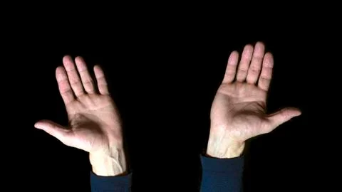 Open hands on black background. Close up. Stock Photos