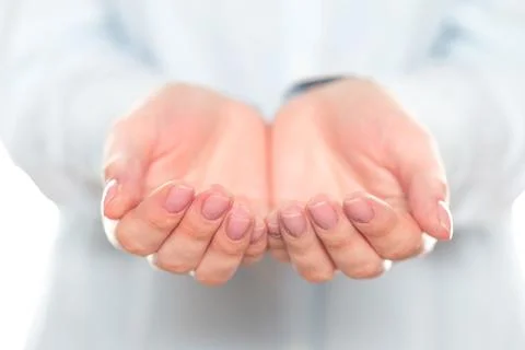 Open hands ready to receive help during a community event in a neutral-colored Stock Photos