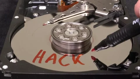 Open hard drive, close-up view, word HACKED written and starting to spin - C Stock Footage 320839517