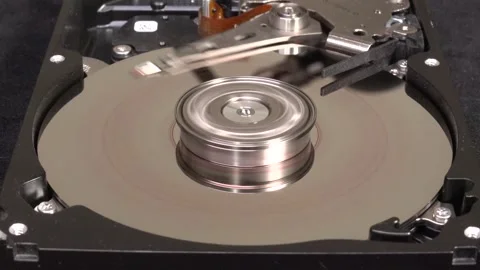 Open hard drive, close-up view, stop spin, word HACKED UN-written - C0013Rev Stock-Footage 321246372