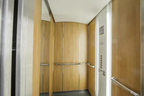 Open high-speed elevator cabin in an office building Stock Photos