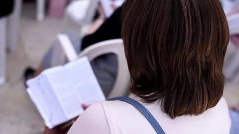 Open holy book Torah in hands of praying woman near Western Wall Stock Footage 243170221