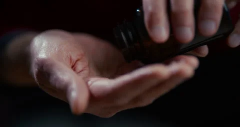 Open human hand palm up in dark low key lighting with isolated background Stock Footage 336136538