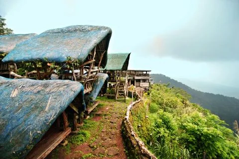 Open huts overlooking a steep cliff Stock Photos