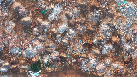 Open illegal dump: abandoned piles of rubble, medical waste and debris on field Stock Footage 145228483