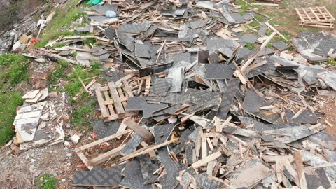 Open illegal dump: destroyed, broken and strewn wood, tiles and debris on field Stock Footage 152441517
