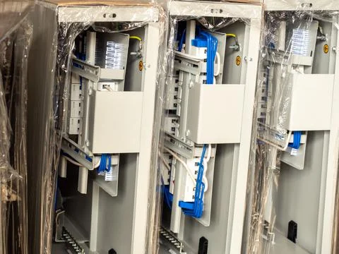 Open industrial electrical control panels with complex wiring blue cables Stock Photos