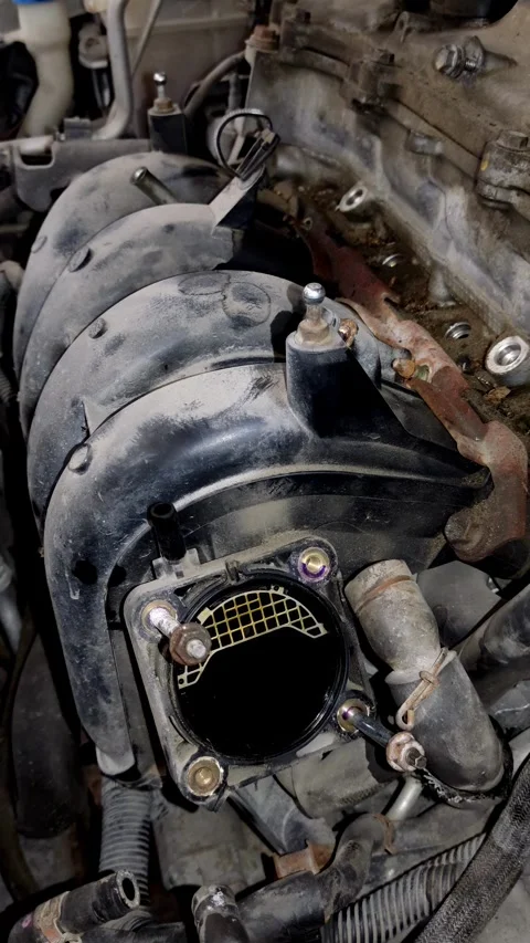 An open intake manifold mounting port on a car engine. Stock Footage 339492013