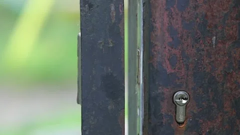 Open the iron gate lock Stock Footage 258074592