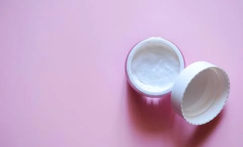 An open jar with cream on a pink background, body and face cream, a beauty .. Stock Photos