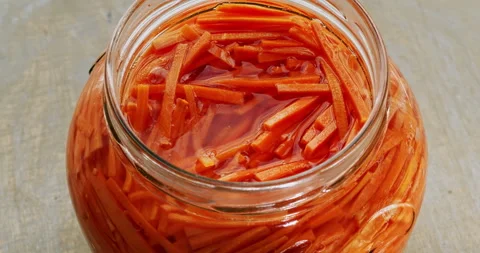An open jar with fermented carrot pickle. Air bubbles goes up. Table spin. Stock Footage 278235568